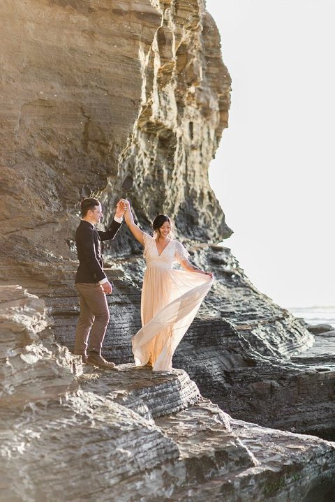 Groom spinning his bride at Sunset Cliffs Elopement