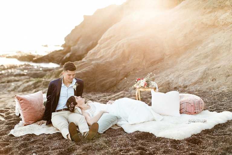 Boho Rodeo Beach elopement couple laying on the beach