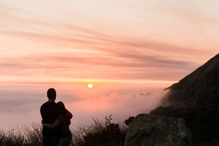Couple watching a sunset in Big Sur