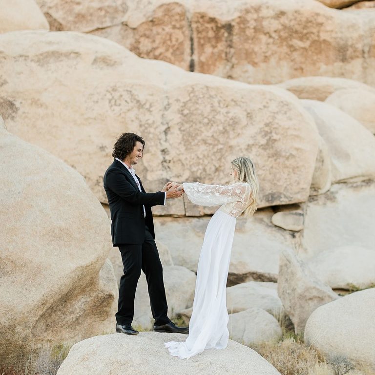 bride and groom on rock formations at Joshua Tree Elopement 