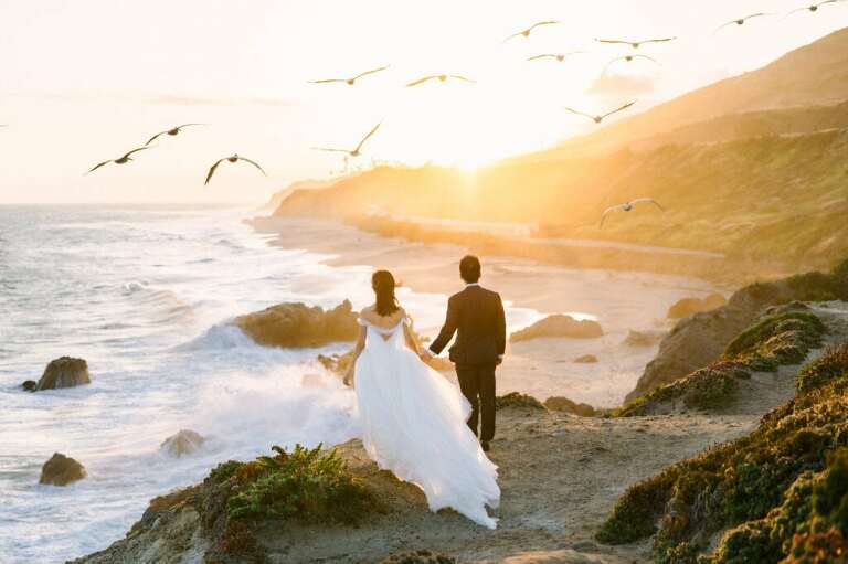 Malibu sunset with birds flying overhead elopement couple